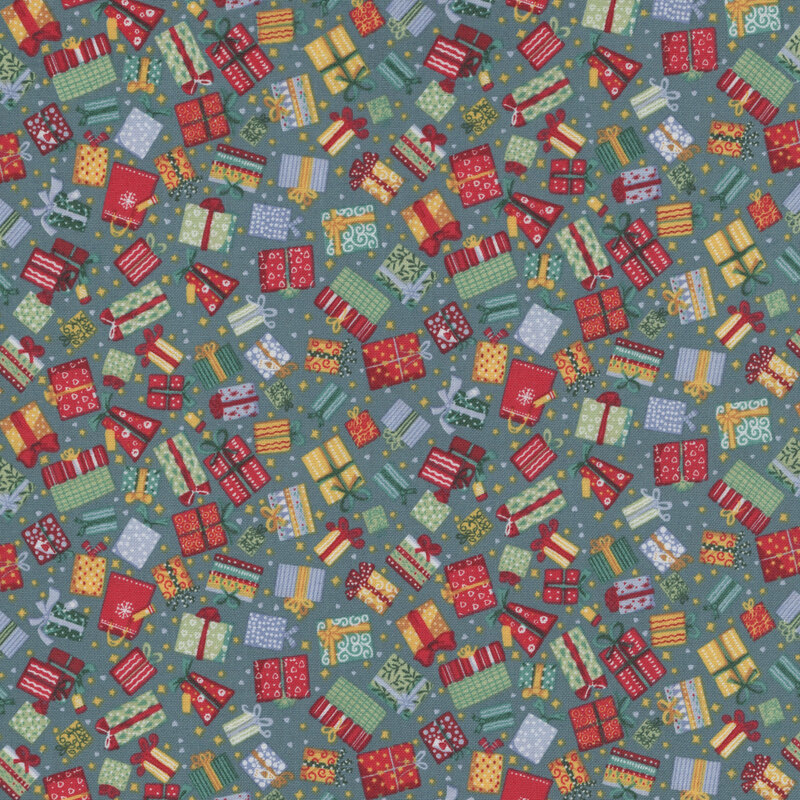 Festive wrapped gifts, hearts, and stars tossed on a hunter green fabric.