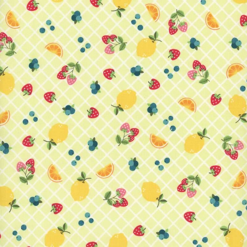 Green fabric with a vibrant fruit pattern with lemons, strawberries, and blueberries.