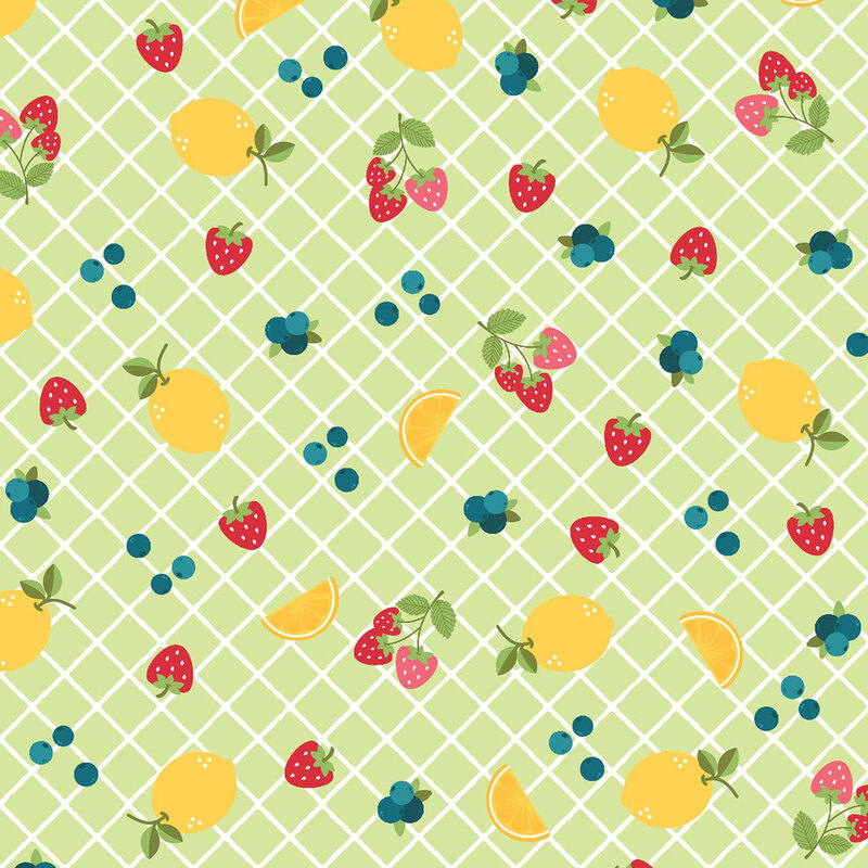 Green fabric with a vibrant fruit pattern with lemons, strawberries, and blueberries.
