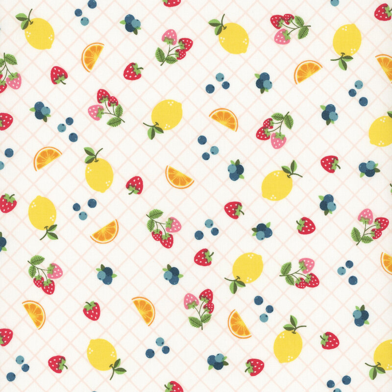 White fabric with a vibrant fruit pattern with lemons, strawberries, and blueberries.