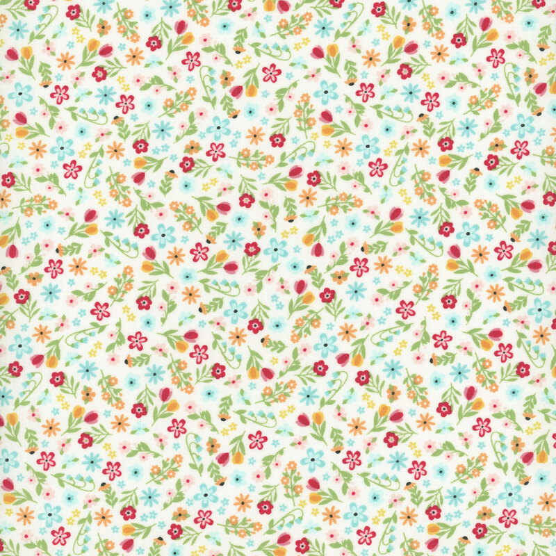 White fabric with a dense array of bright, multicolored calico flowers.