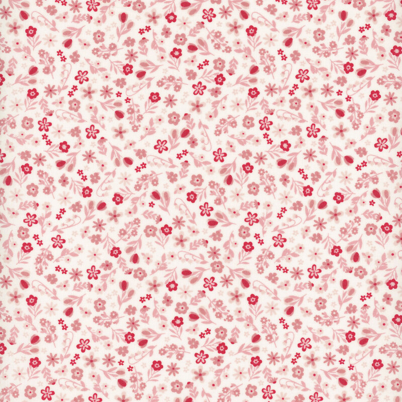 White fabric with a dense pattern of bright red and pink calico flowers.