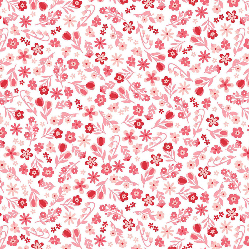 White fabric with a dense pattern of bright red and pink calico flowers.