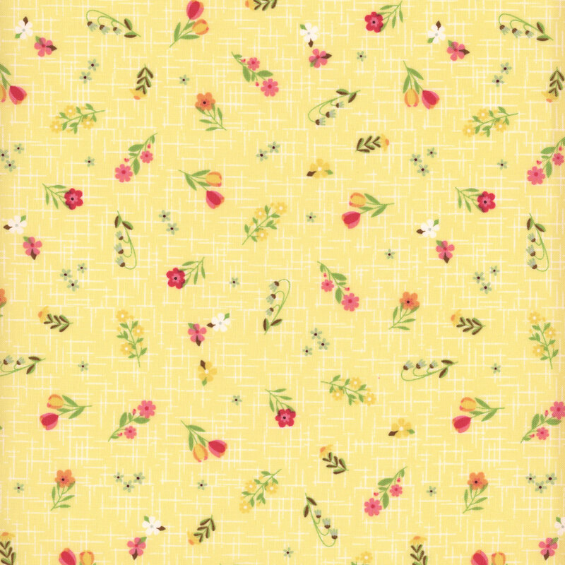 Soft yellow fabric with a pattern of colorful summer florals accented by a subtle textured background.