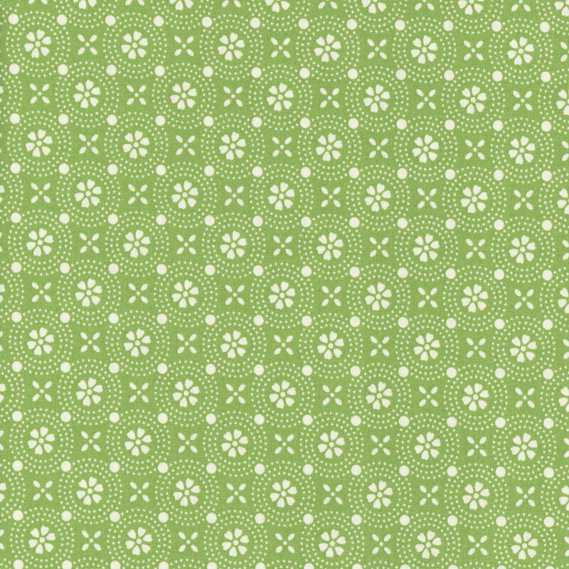 Bright green fabric is with a geometric design of stylized white flowers.