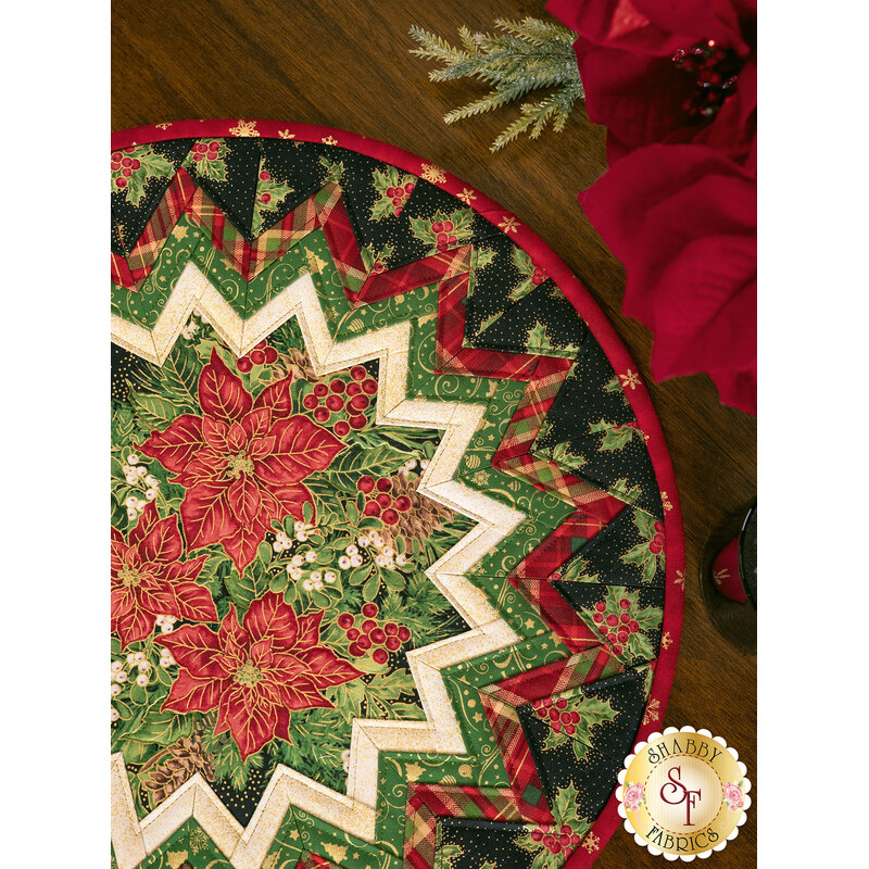 A close up on the outer edge of the topper, showcasing the finished project displayed with poinsettia flowers in the top right corner.