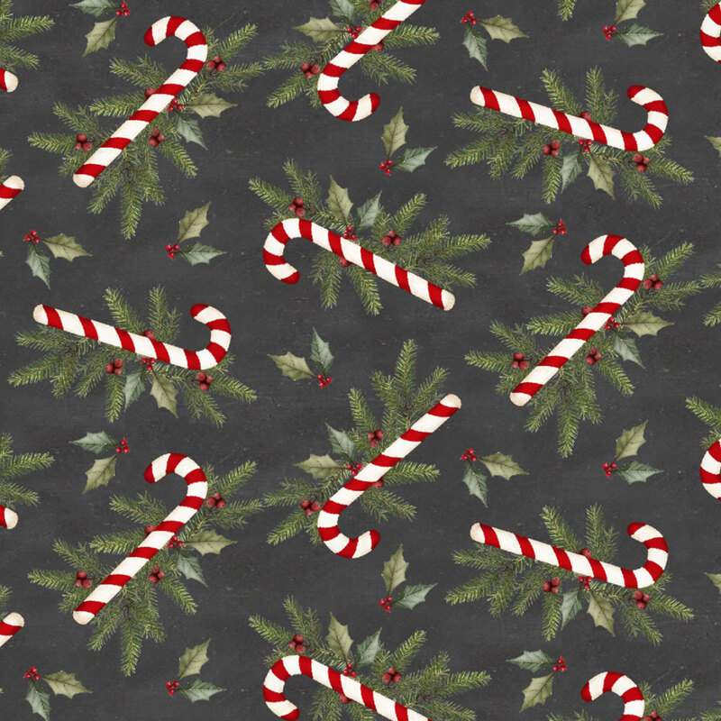Scattered candy canes with green holly leaves and red berries on a mottled charcoal gray background