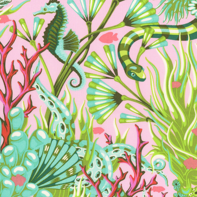 Pink fabric with seahorses, underwater snakes, and salmon pink fish in a colorful, green and aquamarine coral reef