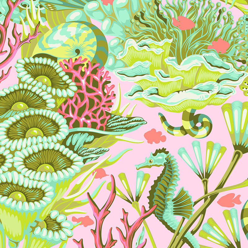 Pink fabric with seahorses, underwater snakes, and salmon pink fish in a colorful, green and aquamarine coral reef