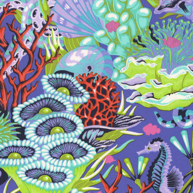 Ultramarine fabric with seahorses, underwater snakes, and hot pink fish in a colorful, green and aquamarine coral reef