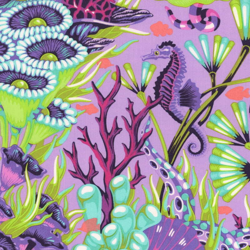 pastel purple fabric with seahorses, underwater snakes, and salmon pink fish in a colorful, green and aquamarine coral reef