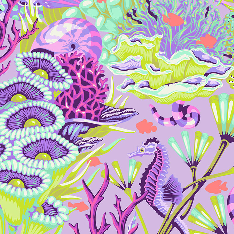 pastel purple fabric with seahorses, underwater snakes, and salmon pink fish in a colorful, green and aquamarine coral reef