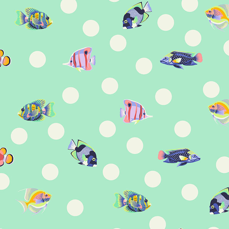 randomly spaced white polka dots and multicolored tropical fish on a seafoam greenbackground 