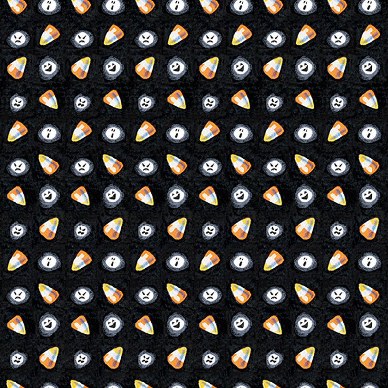 Candy corn and ghostly white faces tossed on black fabric