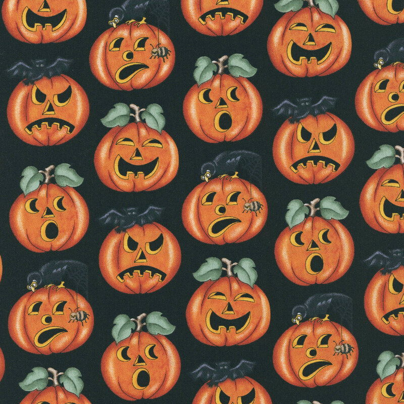 Carved pumpkins, bats, ravens, and spiders tossed on jet black fabric.