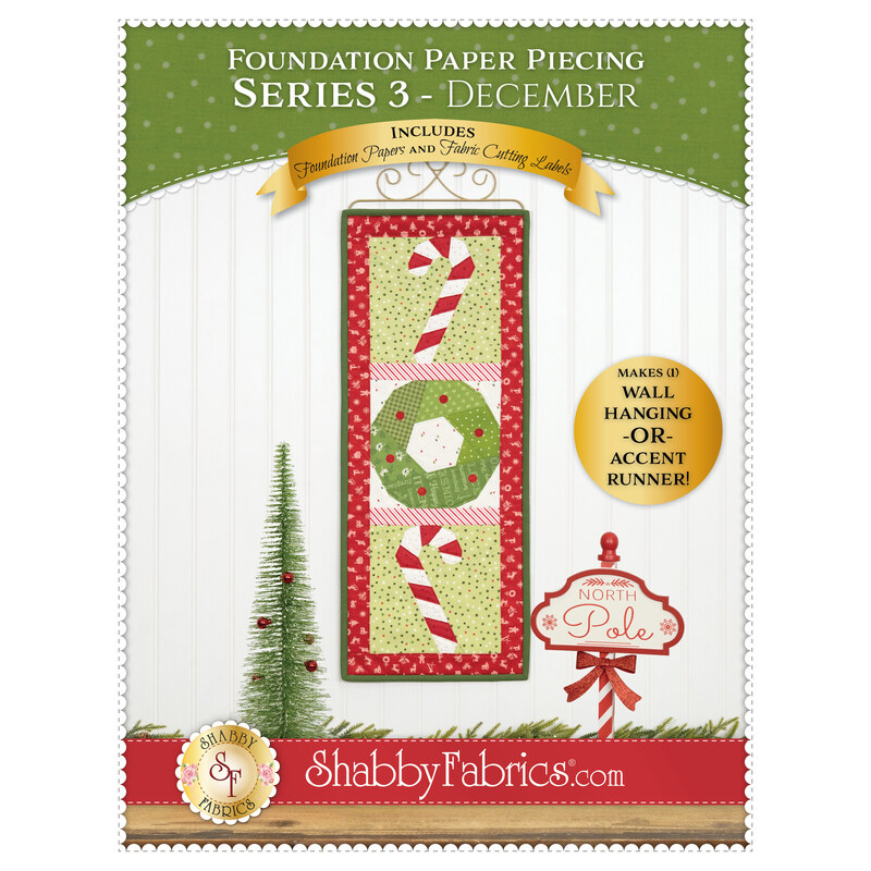 Front cover of the pattern showing the completed wall hanging in bright green, white, and red fabrics depicting two candy canes and a wreath hung on a white paneled wall.