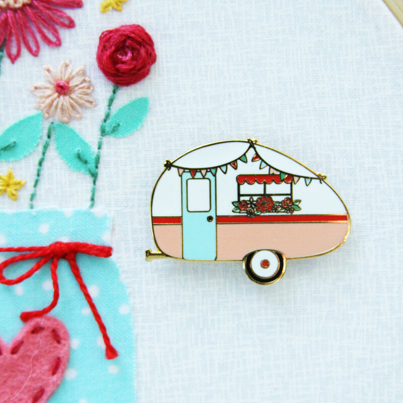 A magnetic vintage camper needle miner displayed on a hand embroidery project 