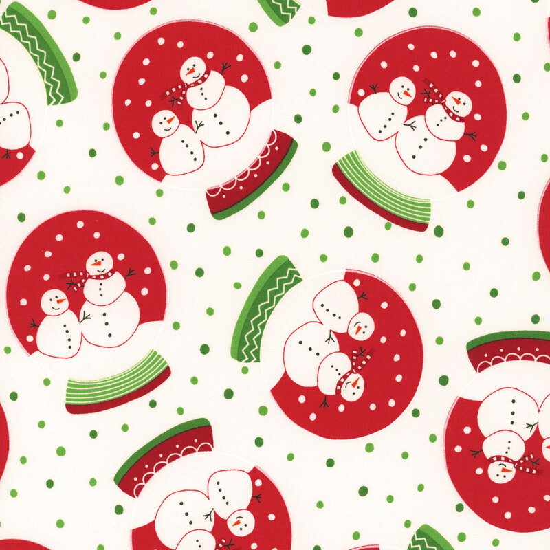 White fabric with green dots featuring snow globes with red dye, white snow, and two festive snowmen with decorated bases.