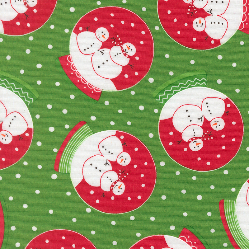 Kelly green fabric with white dots featuring snow globes with red dye, white snow, and two festive snowmen with decorated bases.