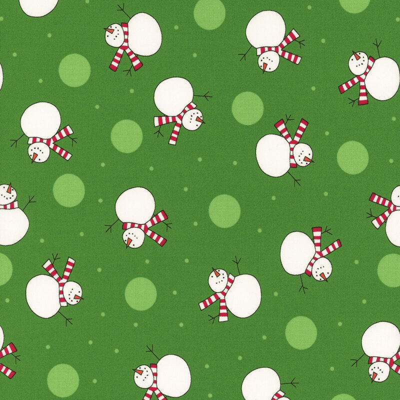 Kelly green fabric featuring scattered white dots and snowmen wearing red striped scarves.
