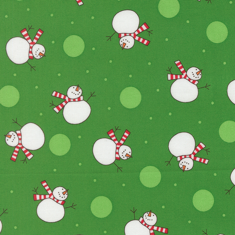 Kelly green fabric featuring scattered white dots and snowmen wearing red striped scarves.