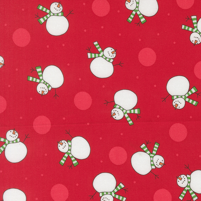 Cherry red fabric featuring scattered tonal dots and snowmen wearing green striped scarves.
