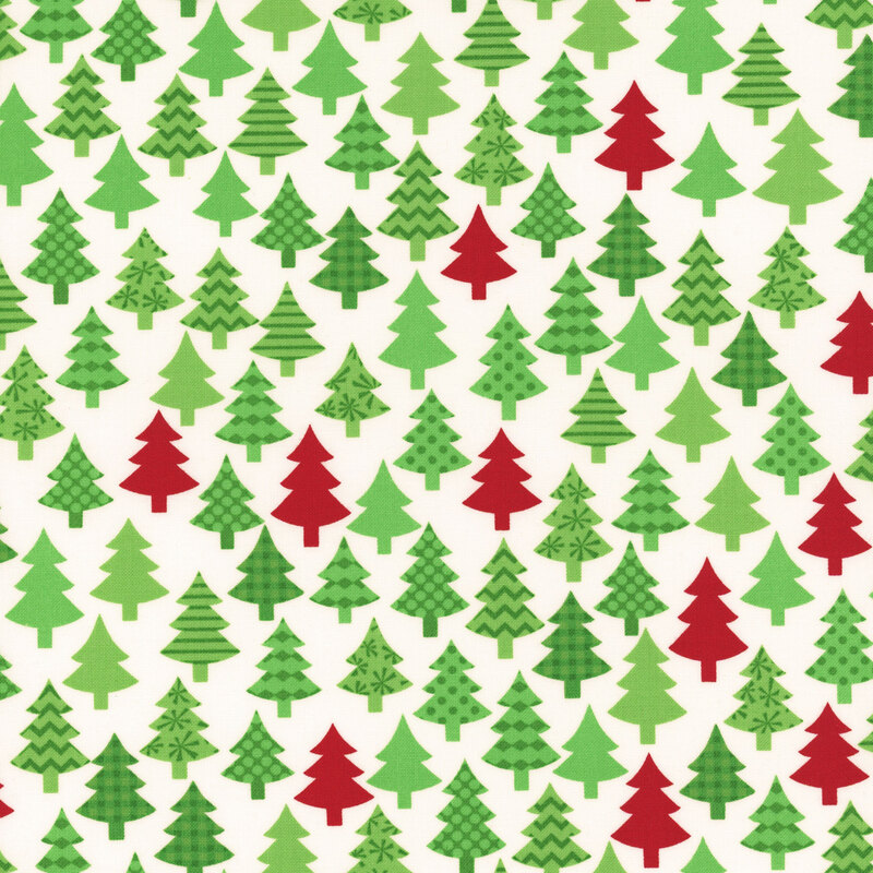 Winter white fabric featuring decorated green and red trees.