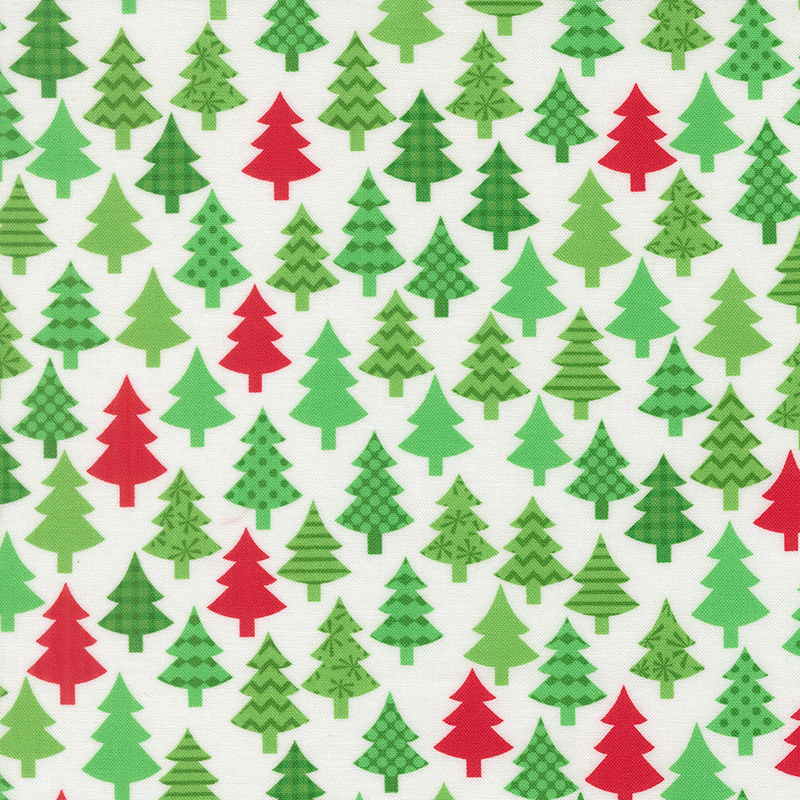 Winter white fabric featuring decorated green and red trees.