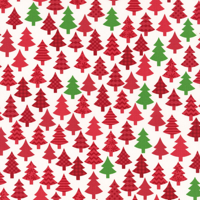 Winter white fabric featuring decorated red and green trees.