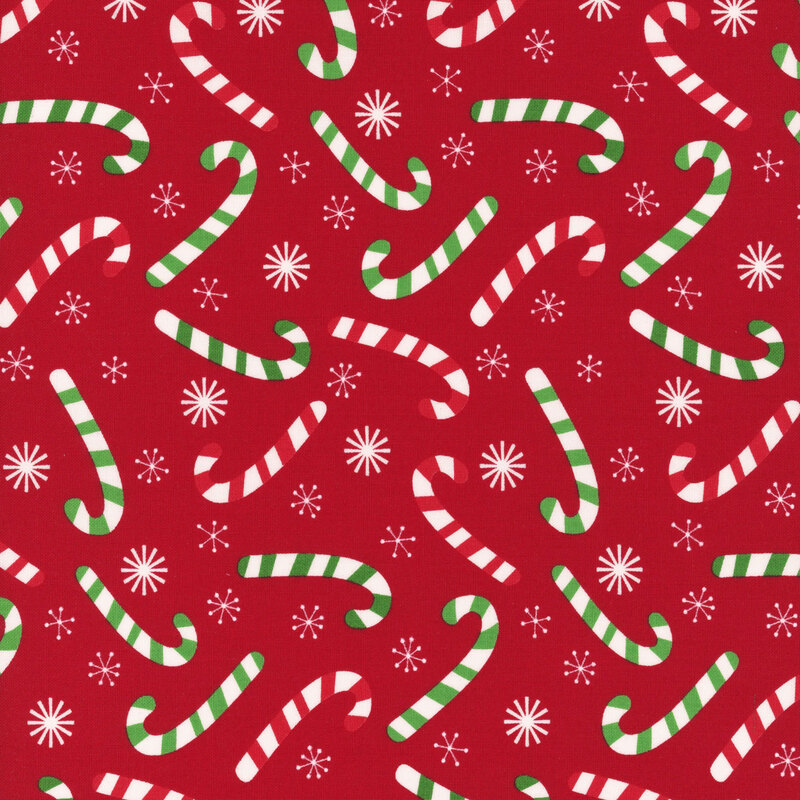 Cherry red fabric tossed with red and green striped candy canes and white snowflakes.