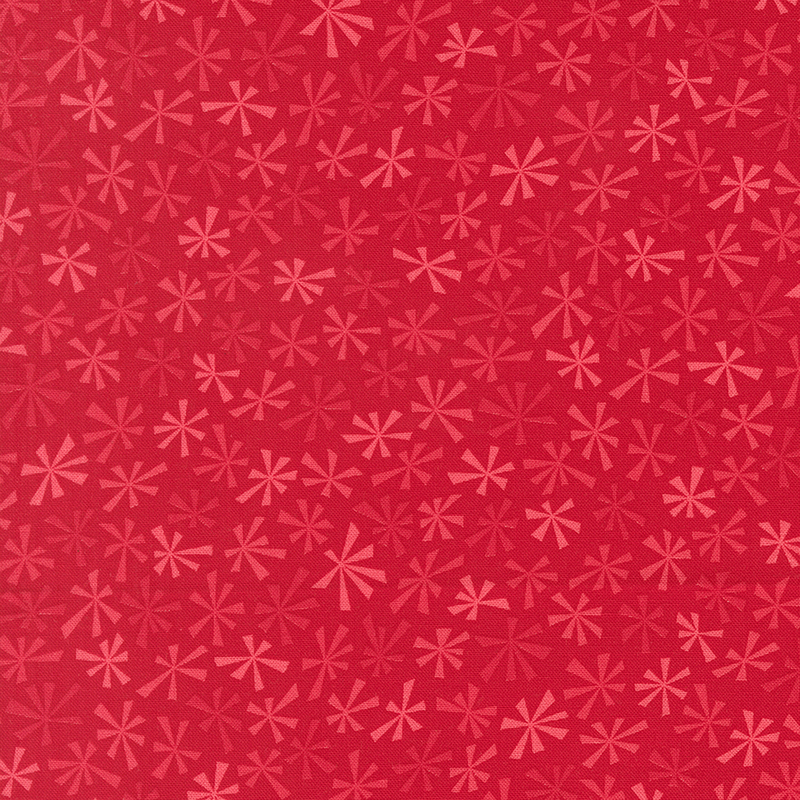 Stylized tonal snowflakes on a cherry red background.