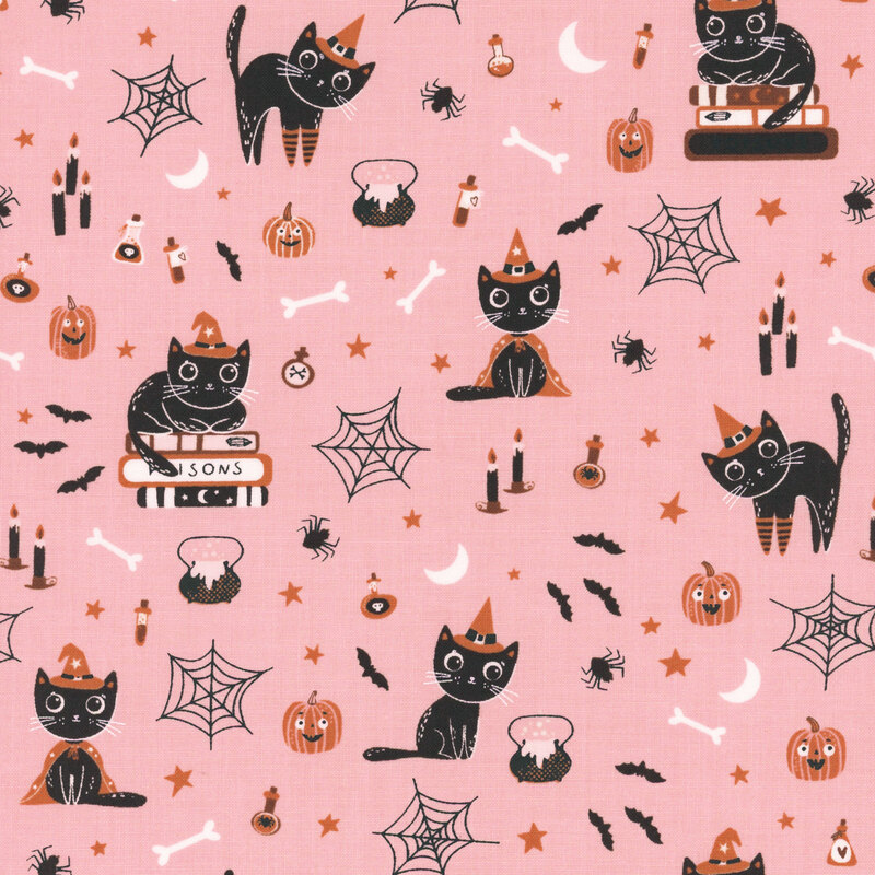 Vibrant pink fabric with witchy cats, smiling pumpkins, scattered stars, and various other Halloween motifs.