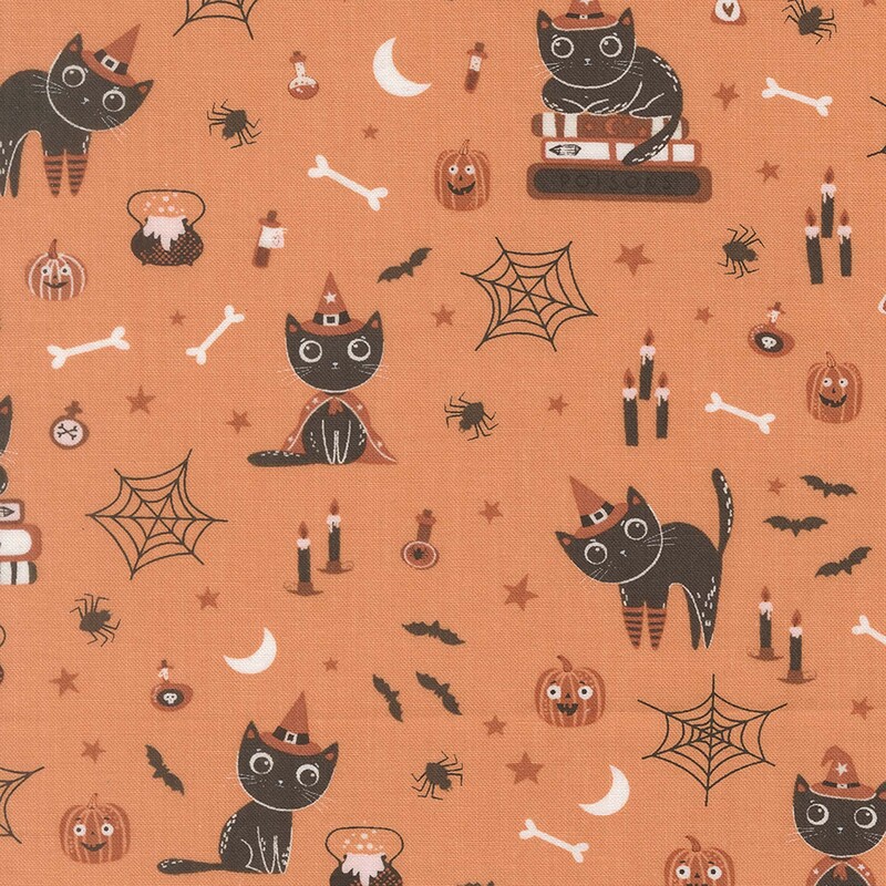 Orange fabric with witchy cats, smiling pumpkins, scattered stars, and various other Halloween motifs.