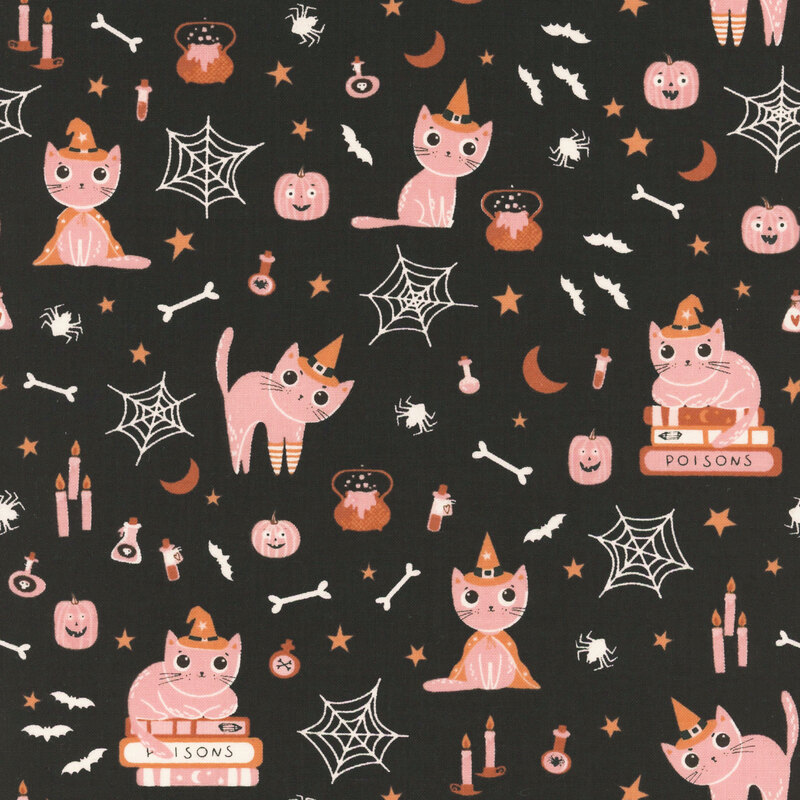 Black fabric with witchy cats, smiling pumpkins, scattered stars, and various other Halloween motifs.