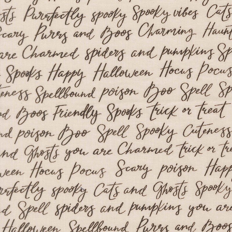 Cream fabric with rows of Halloween-themed words and phrases in cursive script.