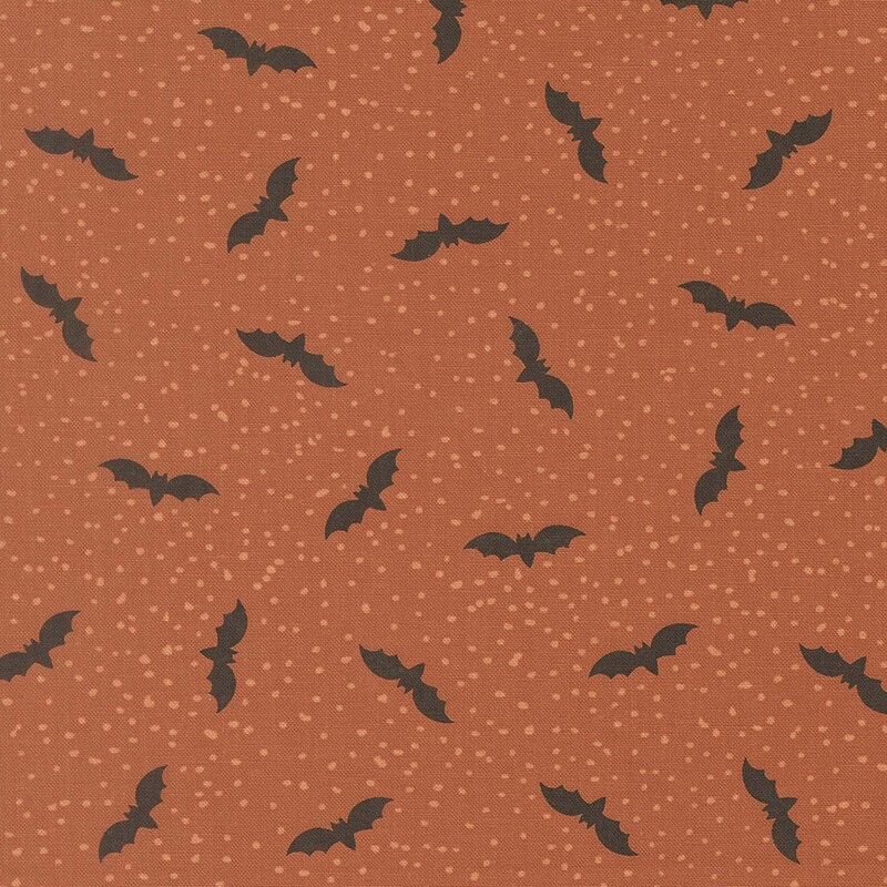 Orange fabric with tiny scattered light dots and flying bats.