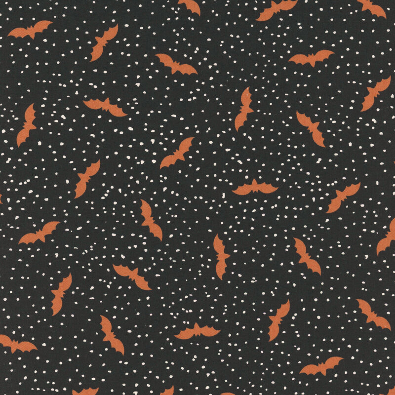 Black fabric with tiny scattered cream dots and flying bats.