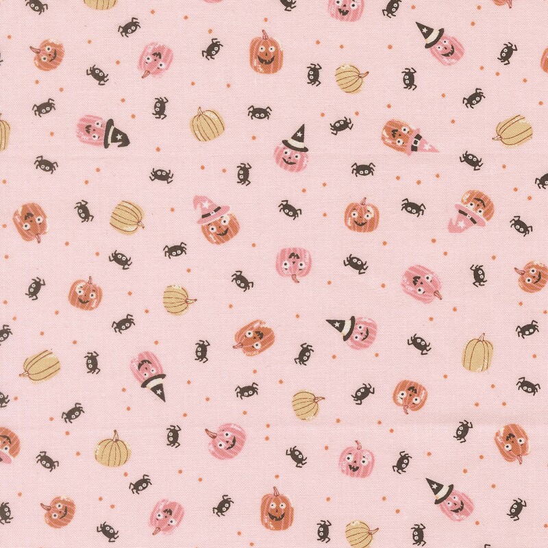 Light pink fabric with tossed pinprick dots, pumpkins, and spiders.