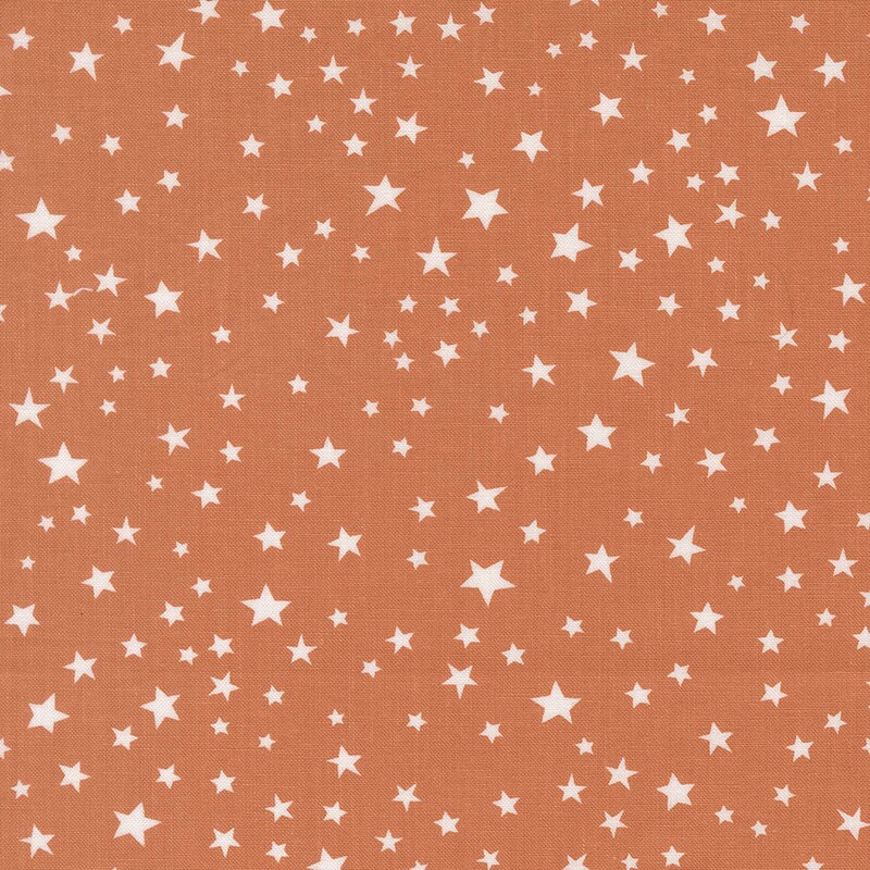 Orange fabric with scattered white stars.