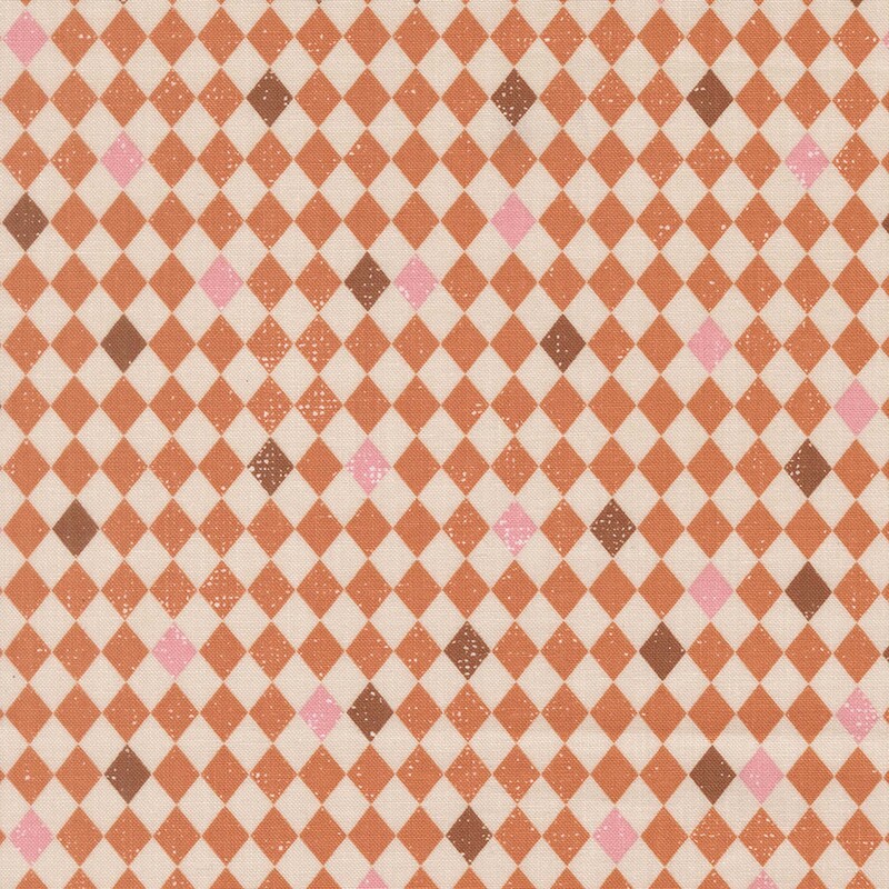 Off-white and orange diamond-checkered fabric with scattered brown and pink tiles.