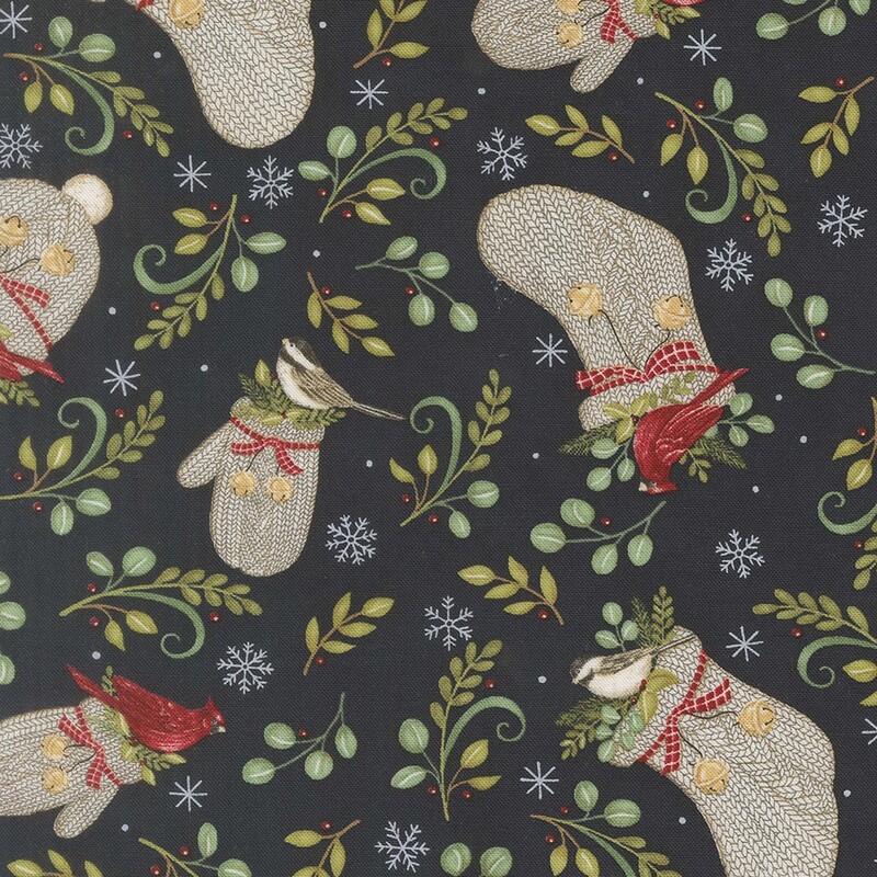 Light beige knitted hats and gloves scattered with green leaves, finches, and cardinals, on midnight blue fabric