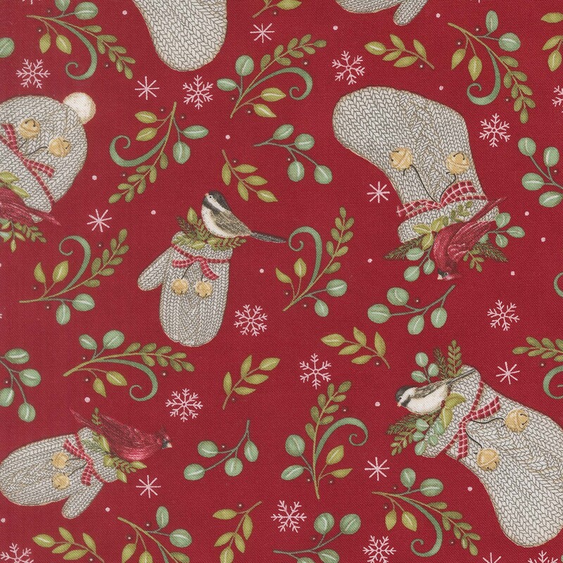Light beige knitted hats and gloves scattered with green leaves, finches, and cardinals, on crimson fabric