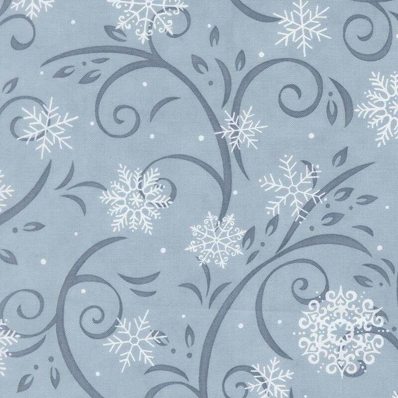 Sky blue fabric with denim blue flourishes and white snowflakes