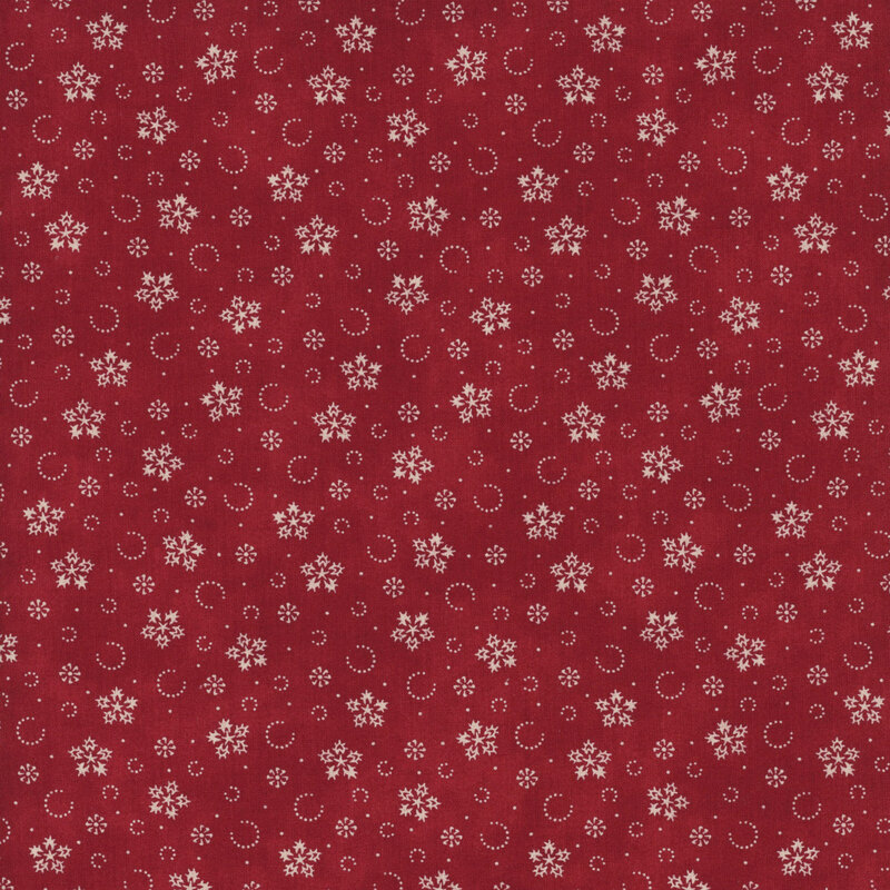 Mottled red fabric with a pattern of stylized snowflakes and tiny pindots.