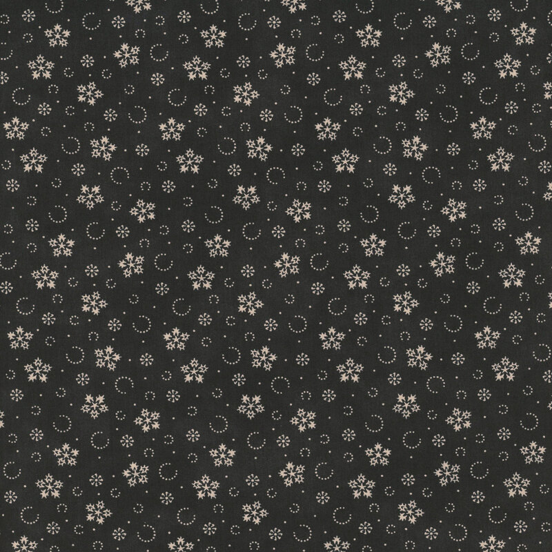 Mottled black fabric with a pattern of stylized snowflakes and tiny pindots.