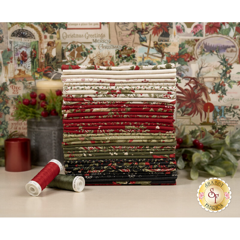 A stack of the fabrics included in the Candlenight Christmas Fat Quarter set, with a panel in the background and mistletoe and candles and thread.