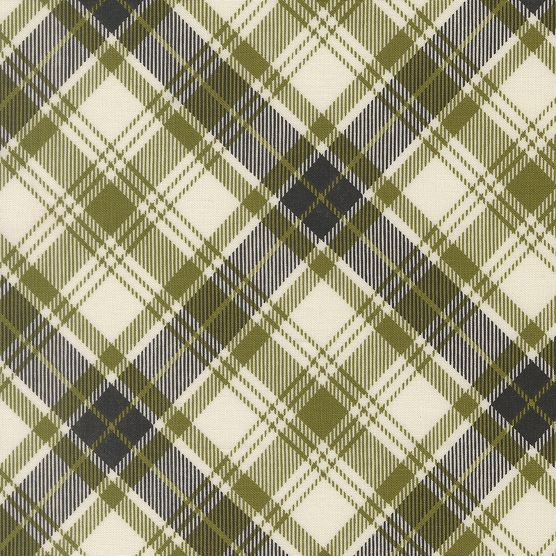 Cream fabric decorated with a timeless diagonal black and green plaid pattern.