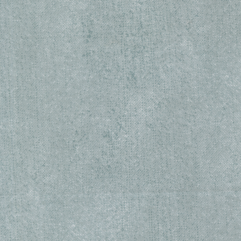 Muted aqua fabric is accented with a textured, grunge-inspired pattern.