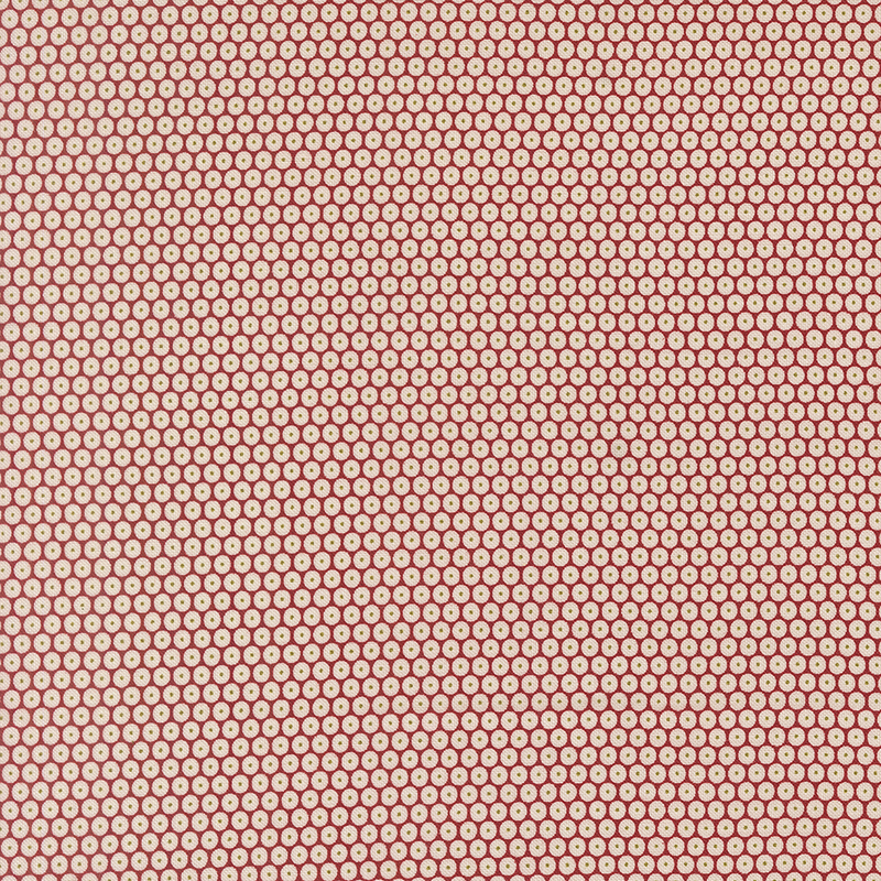 Red fabric is adorned with a dense pattern of white circles accented by green-centered dots.