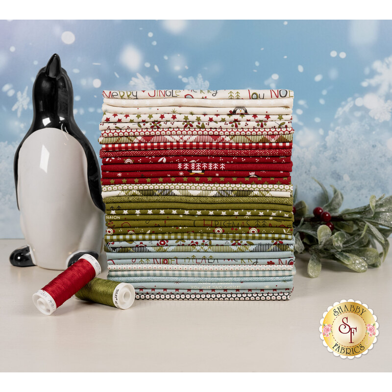 A stack of the fabrics included in the Chilly FQ set, with mistletoe and snow and a penguin and thread.